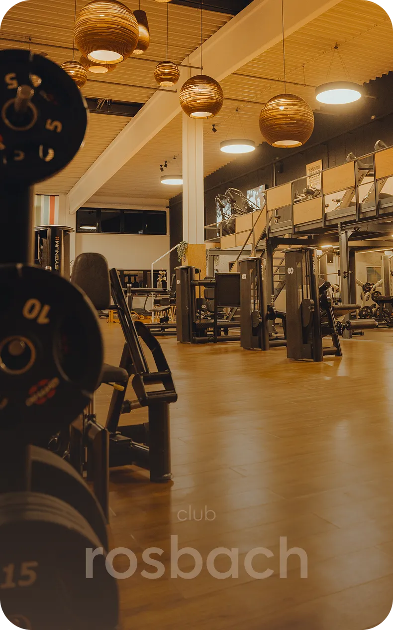 Trainingsfläche mit Geräten und warmen Leuchten im peoples Fitness Club Rosbach
